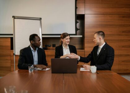 a handshake of two people symbolizing business collaboration with solar panels in the background